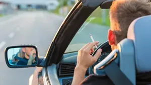 Persona fumando en un descapotable